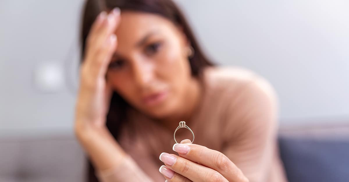 Life After Divorce: Your Surprising Ally For Growth. Woman looking at wedding ring