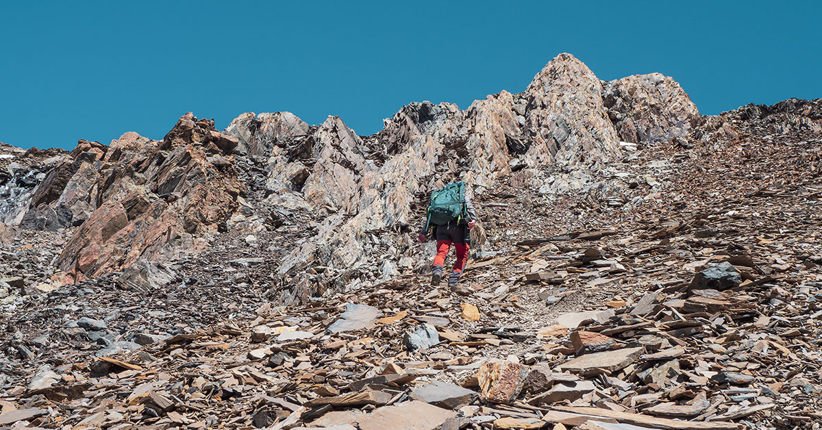 Taking The High Road During Divorce. Man trying to climb steep mountain